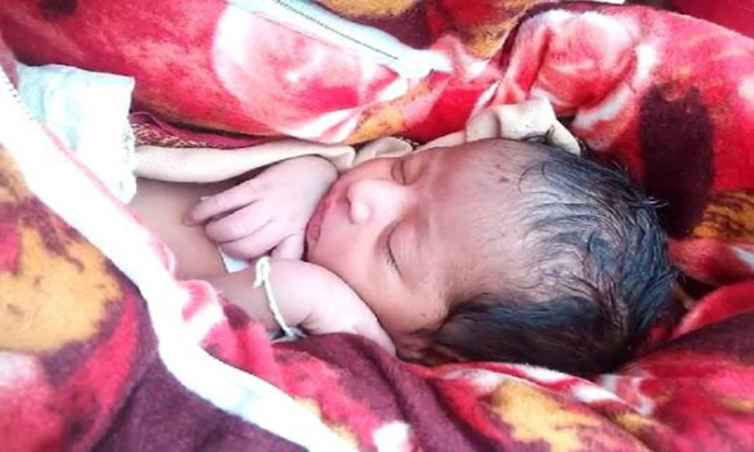 Two held while trying to bury baby alive